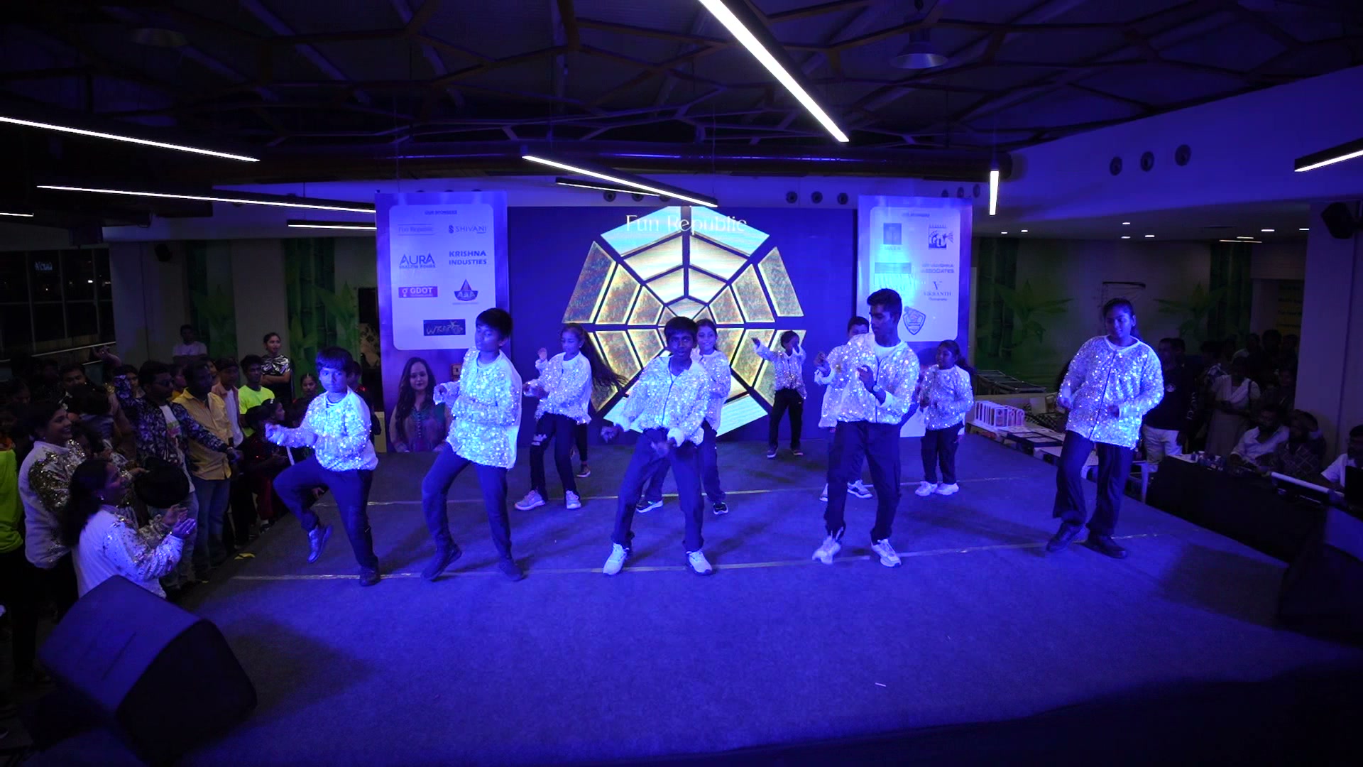 Movementz dancers performing together under stage lights