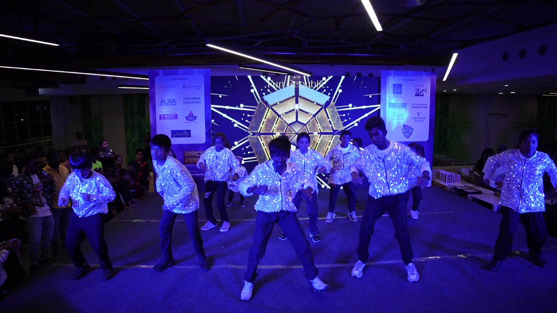 Movementz group performing under blue stage lights